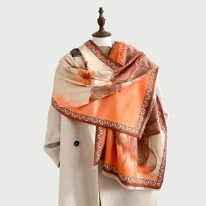 Detail of winter cashmere-like shawl with orange ink wash flower pattern and fringe