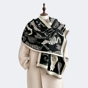 Detail of cashmere-like scarf showing black and white animal print with fringe edges