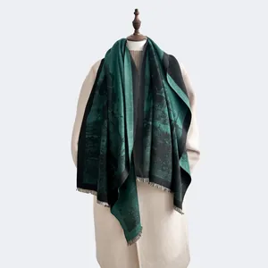 Detail of dark green landscape print scarf with short tassels and soft cashmere texture