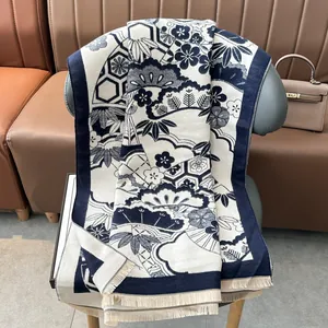 Elegant navy and white cashmere-like scarf with traditional patterns and tassels