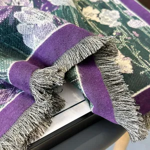 Detailed macro view of vintage floral jacquard pattern with mixed tassel fringe edges