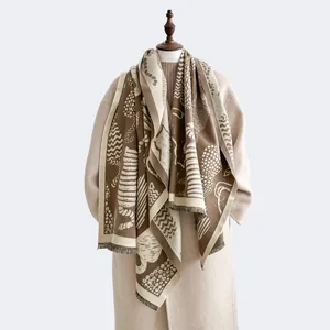 Detail of cashmere-feel shawl featuring artistic patterns and elegant long tassels