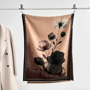 Detail of artistic lotus ink painting and tassel fringe on a warm winter scarf