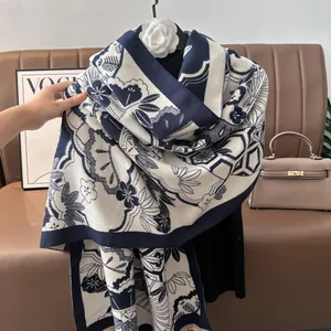 Close-up of navy and cream faux cashmere scarf featuring traditional floral and fan motifs
