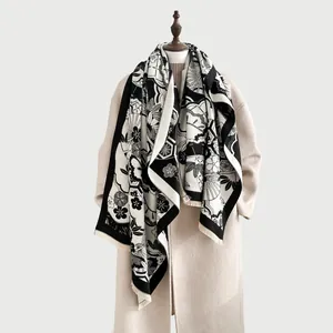 Elegant black and white cashmere-like shawl with traditional floral patterns and fringe edge
