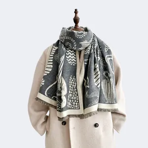 Detail of thick cashmere-feel scarf featuring vintage geometric patterns and fine fringes
