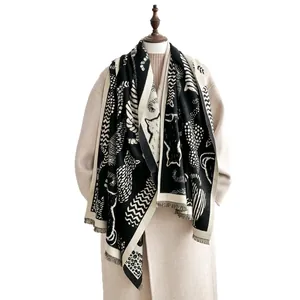 Elegant black and white cat pattern cashmere scarf with tassels on a beige coat