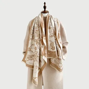Close-up of thick cashmere-like scarf with oriental floral patterns and fringe details