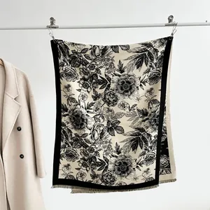 Detail of floral cashmere scarf featuring vintage flower print and delicate fringe edges