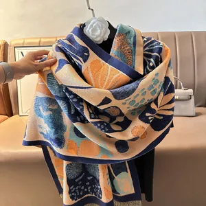 Detail of artistic abstract print scarf with tassel edge on a camouflage hanger