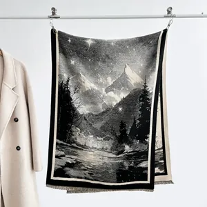 Detail of woven snow mountain pattern on black and white cashmere-like fringed scarf