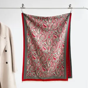 Detail of vintage paisley pattern scarf with elegant beige fringe and jacquard texture