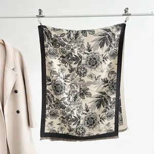 Detail of floral cashmere-like scarf with vintage black roses and fringe trim