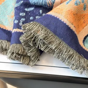 Macro shot of woven texture and fringe details on abstract oil painting cashmere scarf