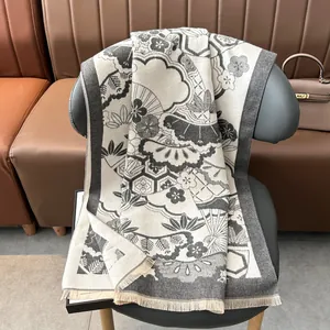 Detail of grey cashmere-feel shawl with traditional fan and floral jacquard patterns