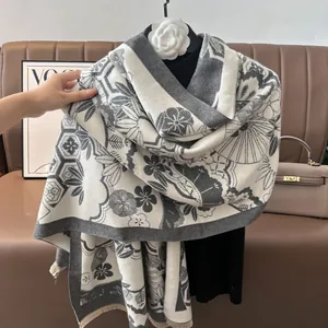 Detail of soft cashmere feel scarf with vintage floral patterns and fringe edges