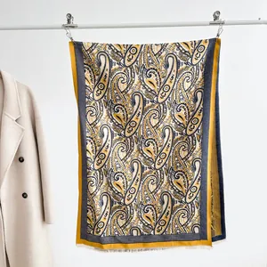 Detailed close-up of retro paisley pattern on a thick jacquard scarf with cream tassels
