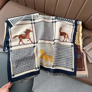 Detailed view of horse motif knit scarf with thick fabric texture and tassel edges
