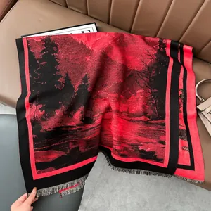 Detail of red and black landscape cashmere scarf featuring long fringes and silky texture