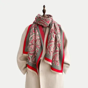 Detailed view of beige paisley shawl with vintage floral patterns and fine fringe trim