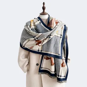 Detail of horse print scarf with houndstooth and chain patterns featuring fringed edges