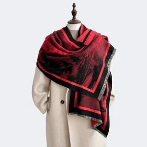 Close-up of artistic red and black landscape scarf with fringe on beige coat