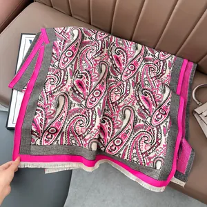 Detailed macro view of the soft paisley jacquard pattern with fringe on the woven shawl