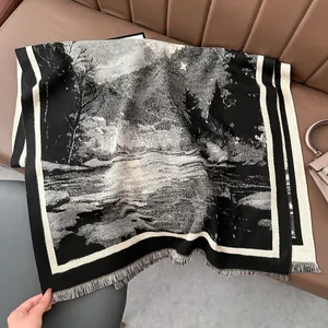 Close-up of black and white landscape cashmere feel scarf with tassel edges on leather