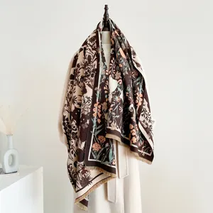 Thick autumn winter scarf with floral print and fringe details on a wooden mannequin