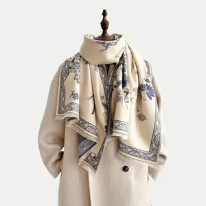 Dettaglio dello scialle di cashmere blu con nappe e motivi tradizionali di loto cinese