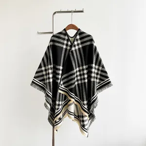 Detailed view of black and white plaid cashmere-like shawl with elegant fringe edges