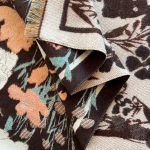 Close-up of winter scarf showing jacquard weave texture and multicolor tassel edges