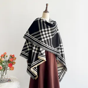 Detailed view of black and white plaid shawl with thick fringe edge on a mannequin
