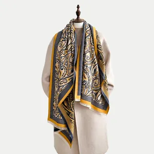 Detail of winter scarf featuring ethnic paisley patterns and fine tassel fringe edges