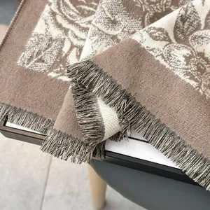 Close-up of thick floral pashmina shawl with tassel fringe and jacquard texture