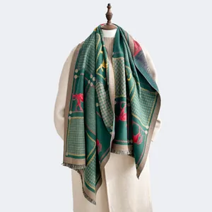 Detailed view of dark green equestrian scarf with horse pattern, tassels and soft texture