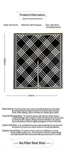 Detail view of plaid poncho wrap with fringes, 100% polyester fabric, 150x130cm