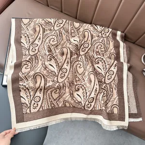 Close-up of beige paisley pashmina shawl showing thick texture and fine fringe detail