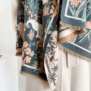 Macro detail of cute cat floral pattern and soft fringe on thick winter cashmere scarf