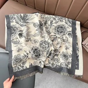 Close-up of floral print cashmere-feel shawl with vintage rose patterns and fringed edges