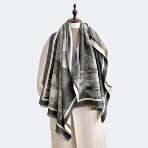Detail of artistic landscape print shawl with delicate fringe on high-quality grey fabric
