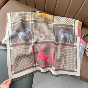 Detail of horse pattern scarf with chain motifs and fringed edges on leather