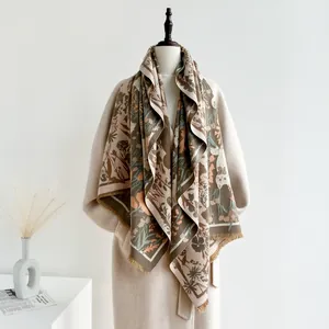 Detailed close-up of brown floral cashmere-feel shawl with fringe edge and autumn plant pattern