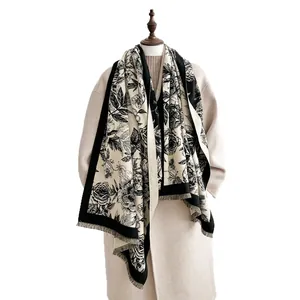 Elegant thick floral faux cashmere scarf with tassels on beige coat mannequin
