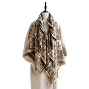 Elegant earth-tone floral print scarf with tassels over a cream coat on white background