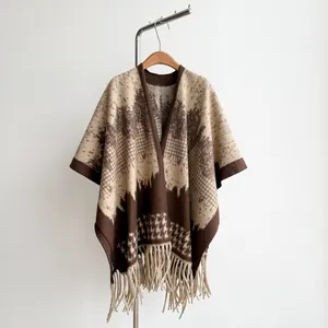 Detailed view of British style houndstooth knit shawl with elegant beige fringe tassels