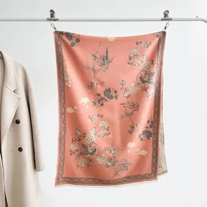 Dettaglio dello scialle pashmina rosa con motivi floreali e uccelli e frange eleganti