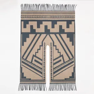 Detail von geometrischen Stammesmustern und Fransen an einem wollartigen Poncho