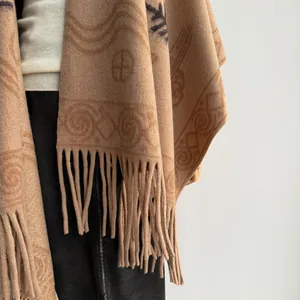 Thick boho cashmere poncho with geometric tribal patterns and fringed hem for women