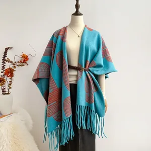 Ethnic style lake blue tassel shawl with red geometric patterns shown on a mannequin
